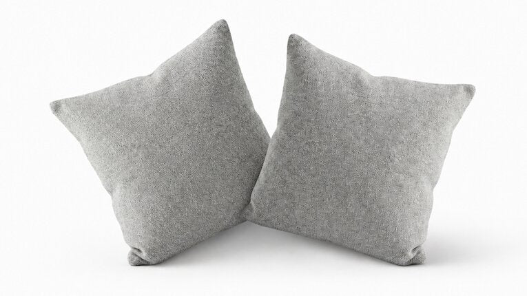 Two grey Eco Cashmere cushion covers, styled with inserts